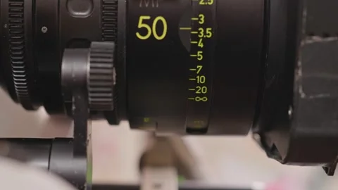 Close-Up of Focus Puller Adjusting 50mm Cinema Lens Distance Scale Rings Stock Footage 346603867