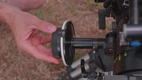 Close-Up of Focus Puller Turning Follow Focus Wheel to Shift Lens Distance .. Stock Footage 346086796