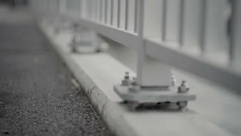 Close Up Focus Shift Of The Bottom Of A Grey Bridge Railing Stock Footage 147130665
