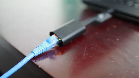 Close up focus shot of Dell USB-C Ethernet adapter operating Stock Footage 102190332