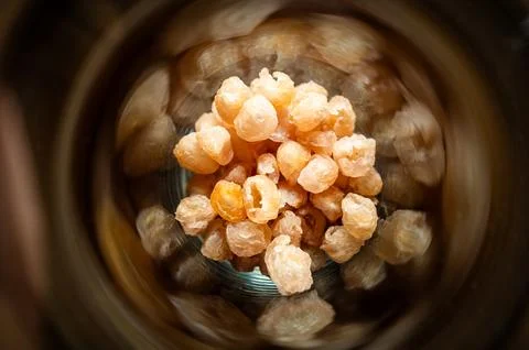 Close focus on small dried longans preserved inside glass jar. Stock Photos