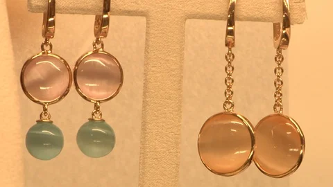Close-up, focus of two pairs of gold earrings with pearls Stock Footage 120737394