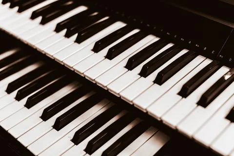 Close focus on upper row of piano with warm tone of black and white. Stock Photos