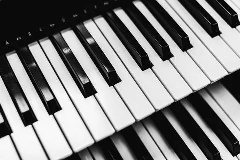 Close focus on upper row of piano with warm tone of black and white. Stock Photos