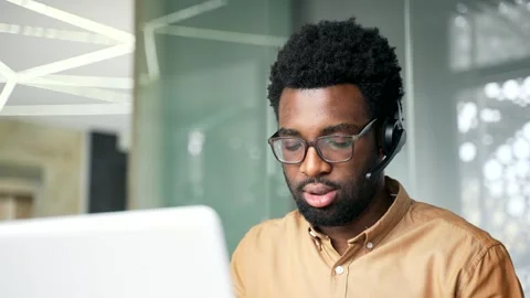 Close up of focused African American customer support agent wearing headset  Видео 337499301