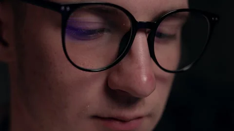 Close up focused face of programmer in computer glasses with monitors reflection Stock Footage 259829215