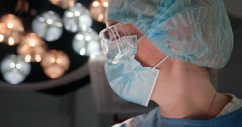 Close-up of a focused female surgeon in operating room Stock Footage 302715035