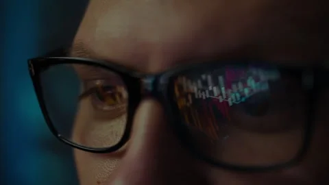 Close-up of focused person analyzing data on a screen at night in a dimly li Stock Footage 295894421