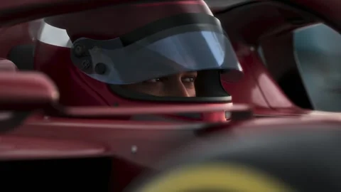 Close-up of a focused pilot driver in a red racing car, preparing for a race Stock Footage 300990857