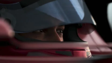 Close-up of a focused pilot driver in a red racing car, preparing for a race Stock Footage 300991412