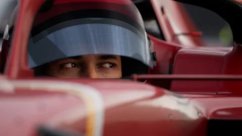 Close-up of a focused pilot driver in a red racing car, preparing for a race Stock Illustration