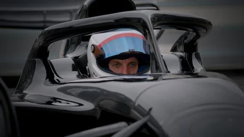 Close-up of a focused pilot driver in a red racing car preparing for a race Stock Photos