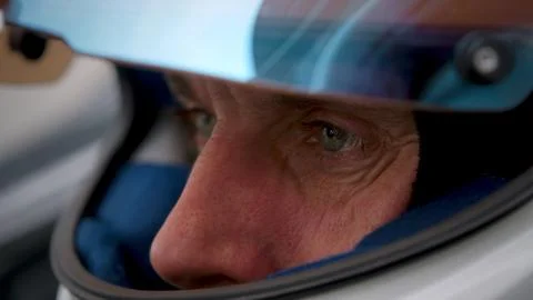 Close-up of a focused pilot driver in a red racing car preparing for a race Stock Photos