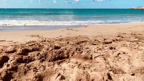 Close up focused sandy beach blurred sky sunlight Cyprus. Beach sand close up wh Stock Footage 218231293
