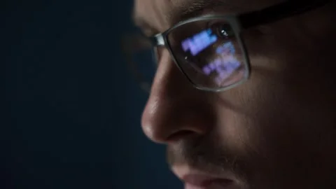 Close up of focused software engineer wearing glasses, analyzing code on screen Stock Footage 303998411