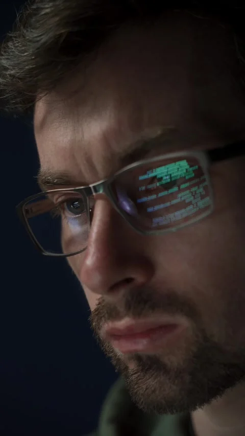 Close up of focused software engineer wearing glasses, analyzing code on screen Stock Footage 303998436