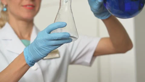 Close-up. Focused young life science professional pipetting solution into the Stock Footage 95550112