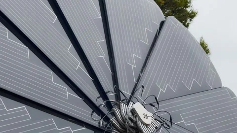 Close-up of a foldable solar panel array with cables and control unit, showing Stock Footage 336803402
