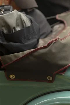 Close-up of folded canvas bag and jacket on vintage scooter seat Stockfoto's