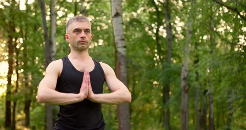 Close up of folded palms men portrait meditate in park in morning. Yoga practice Stock Footage 156788025