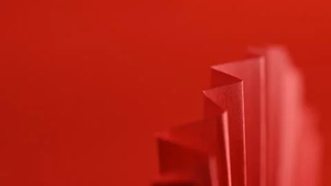 Close up of folded red paper texture with zig-zag pattern against a matchin.. Stock Photos