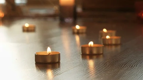 Close-up folden and red Prayer Tea Candles on the floor Stock Footage 106449881