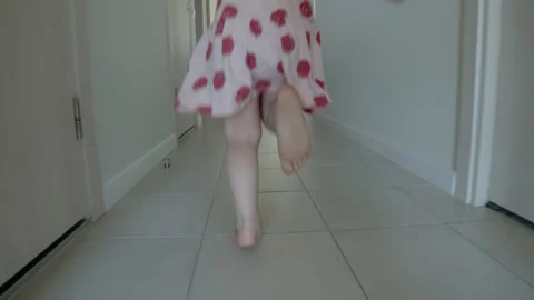 Close up follow handheld close-up of children feet running through apartment Stock Footage 201010668