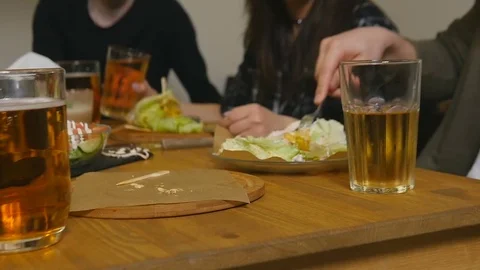 Close up food and drink on table and female hand takes a mug of beer Stock Footage 77378452
