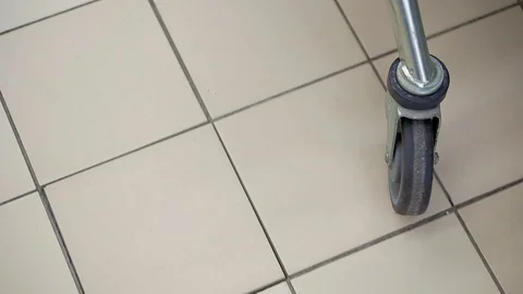Close-up of food cart wheel rides on the floor Видео 99677341
