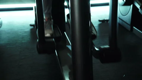 Close-up of a foot on an elliptical training machine in the gym. Stock Footage 88577289
