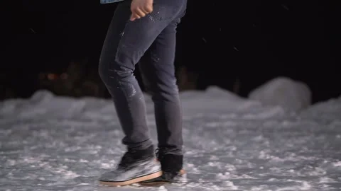 Close-up foot of a guy walking on a snowy street Stockbeeldmateriaal 147071256