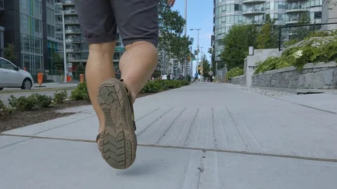 Close up to the foot of a man while walk... | Stock Video | Pond5