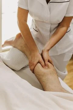 Close up of foot massage therapy session. Female massage therapist's hands. Fotos Stock