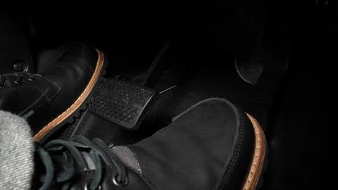 Close up foot press or push foot break and accelerate pedal of a car to dri.. Stock Photos