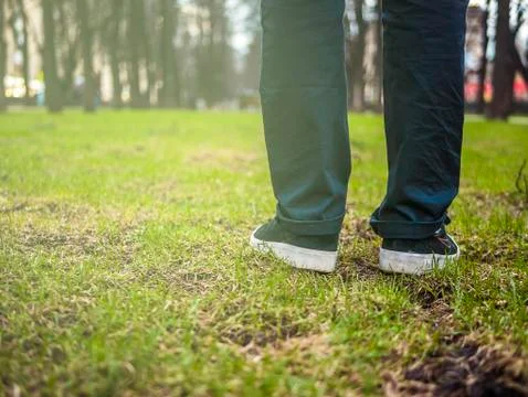 Close up foot steps on the grass Stock Photos