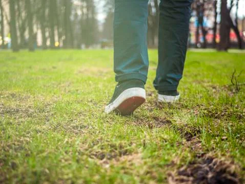Close up foot steps on the grass Stock Photos