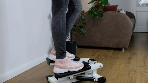 Close up foot working out on the stepper exercise machine at home, stepper Stock Footage 128350568