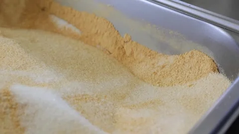 Close-up Footage of Assorted Bread Crumbs or Flour in a Metal Container Stock Footage 331955922