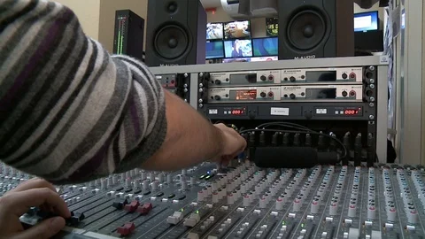 Close up footage of audio mixer knobs being pulled up and down by a man, footage Video stock 71360477