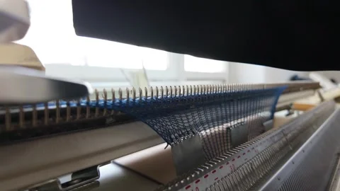 Close-up footage of automated knitting machine working with blue yarn creat.. Stock Footage 336245654