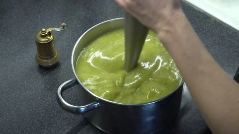 Close up footage of blending process of  green vegetable cream soup in a po.. Stock Footage 303995000