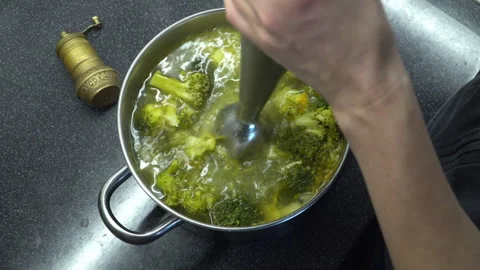 Close up footage of blending process of  green vegetable cream soup in a po.. Stock Footage 303995002