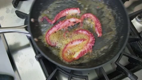 Close up footage of chef preparing octopus with butter in frying pan Stock Footage 221862597