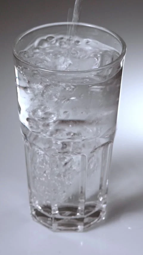 Close-up footage of a clear empty glass being filled with clean fresh water.. Stock Footage 342216120
