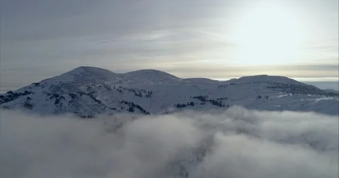 Close-up footage of clouds passing over high mountains covered with snow Stock Footage 119471476