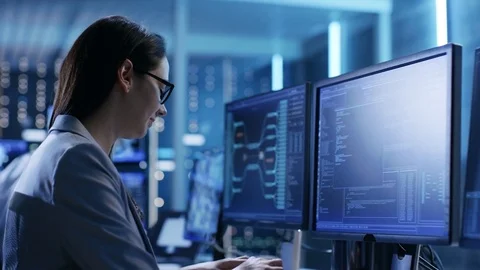 Close-up Footage of Female IT Engineer Working in Monitoring Room.  Stock Footage