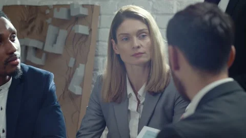 Close-up footage of group of office workers sitting at meeting room and Stock Footage 189032907