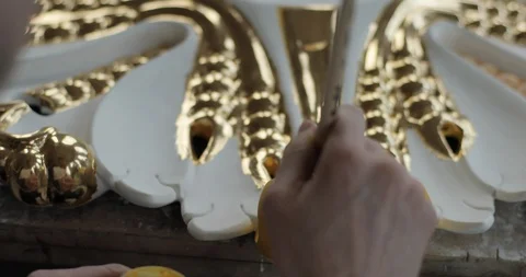 Close-up footage of a hand carefully customizing a household ornament with Stock Footage 123070912