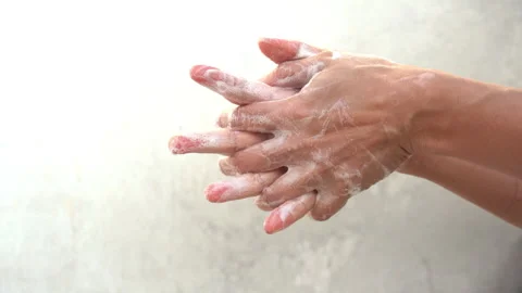 Close-up footage of hands being washed thoroughly with soap and water. Stock Footage 342710495