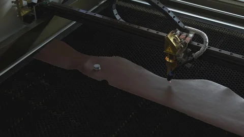 Close-up footage of laser machine engraving holy bible quote on leather sheet Stock Footage 125478355